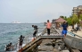 A tourist, along with guides, returns after an open-water diving session near Rasfannu Beach in Malé on May 15, 2026. Photo by Mohamed Afrah / AFP