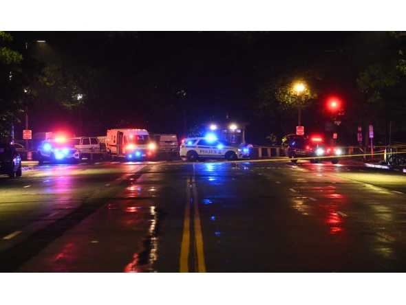 Police vehicles and tape blocks off a crime scene near the White House after a gunman opened fire in Washington, DC, on May 23, 2026. (Photo by Alex Wroblewski / AFP)