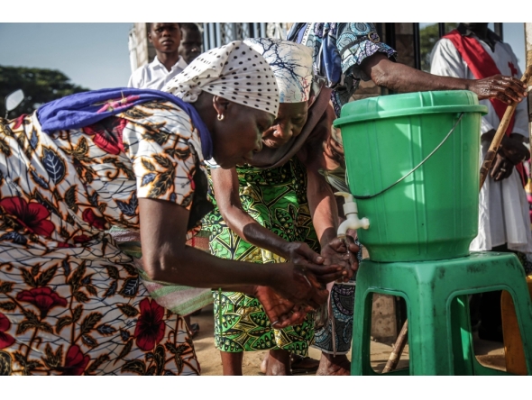 Parishioners wash their hands before entering the church following local authorities’ instructions to limit the spread of the Ebola outbreak in eastern Democratic Republic of the Congo in Bunia on May 24, 2026. (Photo by Seros Muyisa / AFP)
