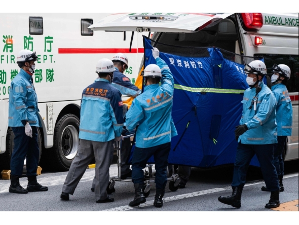 A person is taken on a stretcher to an ambulance by paramedics at the Ginza 6 Shopping Center in Tokyo on May 25, 2026, after an individual allegedly sprayed a substance in the area. (Photo by Andrew Caballero-Reynolds / AFP) 