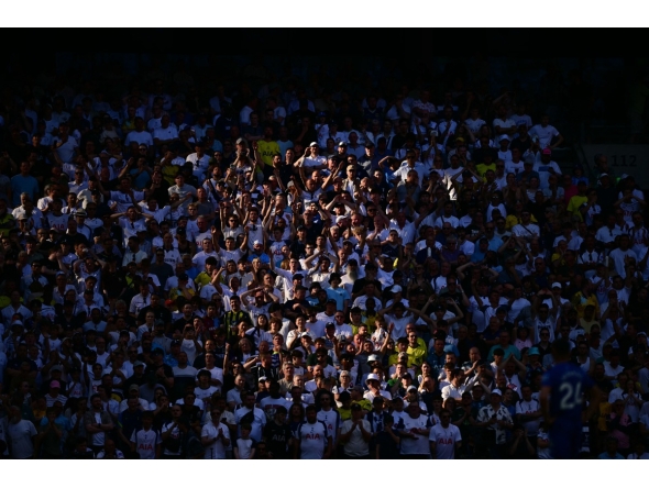 Spurs fans watch in the sunshine during the English Premier League football match between Tottenham Hotspur and Everton at the Tottenham Hotspur Stadium in London, on May 24, 2026. Photo by Ben STANSALL / AFP