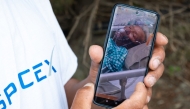 Karma Gyaljen, a relative of mountaineer Dawa Sherpa, shows a photograph of Dawa Sherpa undergoing treatment in the intensive care unit (ICU) at HAMS Hospital in Kathmandu on June 5, 2026. (Photo by Prabin Ranabhat / AFP)