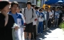 Students line up to enter a school on the first day of China's National College Entrance Examination (NCEE) known as 