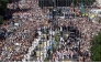 The crowd packs Alcala street as Pope Leo XIV walks under a processional canopy in Madrid on June 7, 2026. (Photo by Pierre-Philippe Marcou / AFP)