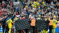 Denmark's and Ukraine's players huddle to accompany Christian Eriksen to a waiting ambulance during the football international friendly match between Denmark and Ukraine at Odense Stadium in Denmark, on June 7, 2026. (Photo by Bo Amstrup / Ritzau Scanpix / AFP)