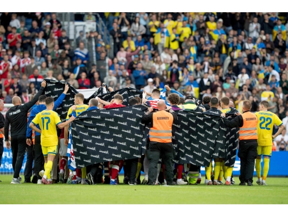 Denmark's and Ukraine's players huddle to accompany Christian Eriksen to a waiting ambulance during the football international friendly match between Denmark and Ukraine at Odense Stadium in Denmark, on June 7, 2026.  (Photo by Bo Amstrup / Ritzau Scanpix / AFP) / Denmark OUT