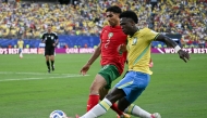 Morocco's defender #02 Achraf Hakimi adn Brazil's forward #07 Vinicius Junior fight for the ball during the 2026 World Cup Group C football match between Brazil and Morocco at the New York/New Jersey Stadium in East Rutherford on June 13, 2026. (Photo by Mauro PIMENTEL / AFP)