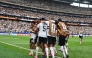 Germany's defender #18 Nathaniel Brown (C) celebrates with teammates after scoring his team's fifth goal during the 2026 World Cup Group E football match between Germany and Curacao at the Houston Stadium in Houston on June 14, 2026.
(Photo by RONALDO SCHEMIDT / AFP)