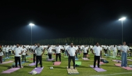 Ambassador of India to Qatar H E Vipul with other participants practising yoga.