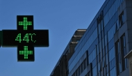 This photograph shows a pharmacy sign displaying the temperature of 44 degrees celsius in Brussels on June 23, 2026. (Photo by Nicolas Tucat / AFP)