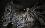 People look at a collapsed building in the Altamira neighbourhood following an earthquake in Caracas on June 24, 2026. (Photo by Federico PARRA / AFP)
 