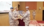 Senior military officials present an award to a graduate.