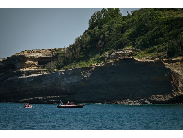 Firefighters search by boat at the base of the cliff from which a section collapsed near Miramar beach, killing one woman and leaving a diver missing, in Biarritz, south-western France, on June 25, 2026. Photo by PHILIPPE LOPEZ / AFP
