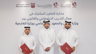 Minister of Justice and Minister of State for Cabinet Affairs H E Ibrahim bin Ali Al Mohannadi with officials from the two entities during the signing ceremony.