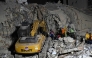 Rescue teams operate heavy machinery at the site of a collapsed building in Caracas on June 25, 2026, following earthquakes. (Photo by Juan Barreto/ AFP)