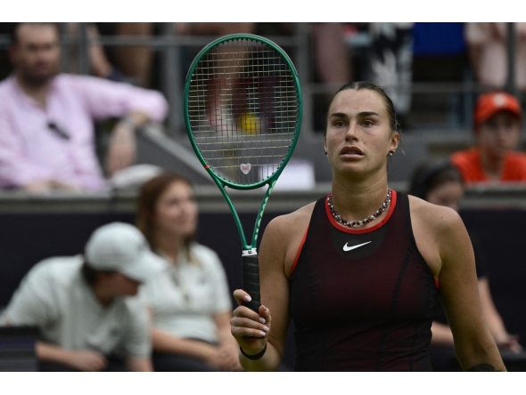 Belarus' Aryna Sabalenka walks back on the tennis court after picking up a new racket from the side as she plays against Jessica Pegula of the US during their women's singles semi-final match at the WTA500 Berlin Tennis Open tournament in Berlin on June 20, 2026. (Photo by John MACDOUGALL / AFP)