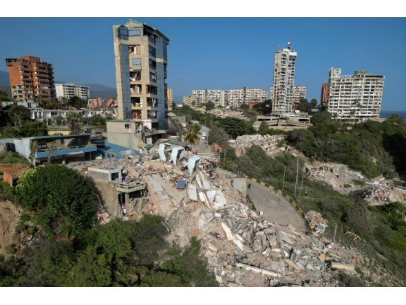 This aerial view shows collapsed buildings in Catia La Mar, La Guaira state, Venezuela, on June 27, 2026, following earthquakes that struck the region. Nearly 1,000 people have been killed and more than 50,000 remain missing after two consecutive earthquakes in Venezuela, where growing anger has been reported over the lack of official aid to swiftly rescue survivors. (Photo by Federico PARRA / AFP)