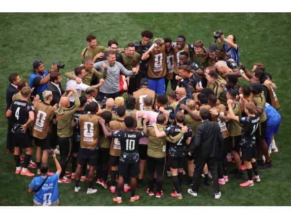Canada head coach Jesse Marsch celebrates with his players in a huddle after the team's victory over South Africa. PIC: AFP