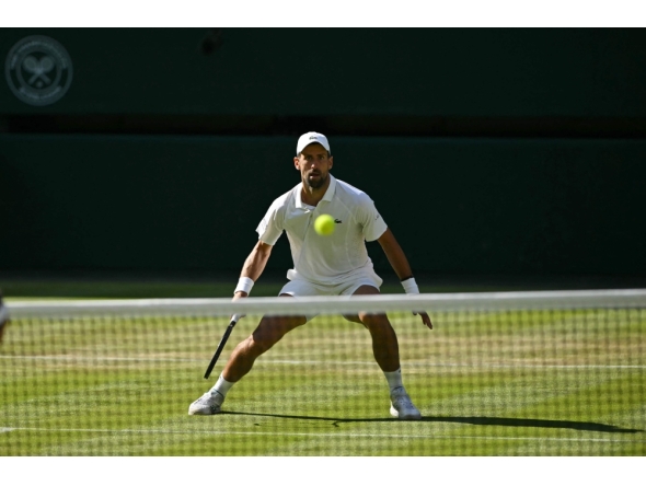 Serbia's Novak Djokovic prepares to return to France's Arthur Rinderknech during their men's singles third round tennis match on the fifth day of the 2026 Wimbledon Championships at The All England Lawn Tennis and Croquet Club in Wimbledon, southwest London, on July 3, 2026. (Photo by Glyn KIRK / AFP) 
 