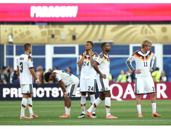 Germany’s players react after losing the penalty shootout against Paraguay.