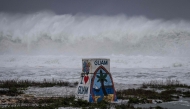 High waves crash against the coastline at a beach as the forecasted Super Typhoon Bavi approaches in Guam on July 5, 2026. (Photo by Yuichi YAMAZAKI / AFP)