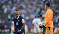 France's forward #10 Kylian Mbappe celebrates past Paraguay's goalkeeper #12 Orlando Gill after winning the 2026 World Cup round of 16 football match between Paraguay and France at the Philadelphia Stadium in Philadelphia on July 4, 2026. (Photo by MAURO PIMENTEL / AFP)