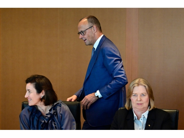 German Chancellor Friedrich Merz walks past German Minister for Research, Technology and Aerospace Dorothee Baer (front L) and German Minister for Labour and Social Affairs Baerbel Bas prior to the weekly cabinet meeting at the Chancellery in Berlin, Germany, on July 6, 2026. (Photo by John MACDOUGALL / AFP)
