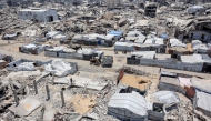 Tents and shelters are pictured next to rubble of collapsed buildings at a camp for people displaced by war in the Sheikh Radwan neighbourhood of Gaza City on July 6, 2026. Photo by OMAR AL-QATTAA / AFP