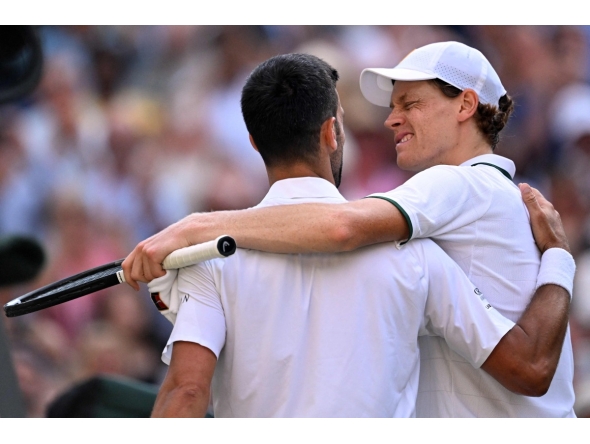 Italy's Jannik Sinner winks at Serbia's Novak Djokovic after beating him during their men's singles semi-final tennis match on the twelfth day of the 2026 Wimbledon Championships at The All England Lawn Tennis and Croquet Club in Wimbledon, southwest London, on July 10, 2026. (Photo by Kirill KUDRYAVTSEV / AFP) 