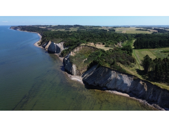 This aerial view shows the Hanklit cliff overlooking Limfjord on the Danish island of Mors, Denmark on July 9, 2026. (Photo by James Brooks / AFP)