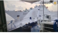 This handout screengrab taken on July 23, 2026 and released by the Philippine Coast Guard (PCG) shows a Chinese Coast Guard ship (back) water canonning a Philippines' Bureau of Fisheries and Acquatic Resources (BFAR) ship near Scarborough Shoal, in the disputed South China Sea. (Photo by Handout / Philippine Coast Guard (PCG) / AFP) /