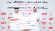 Retail Branches Manager at QIIB Abdullah Hamad Al-Mesaifri presenting the QR1m cheque to the winner, Enas Jamal A S Nasser.