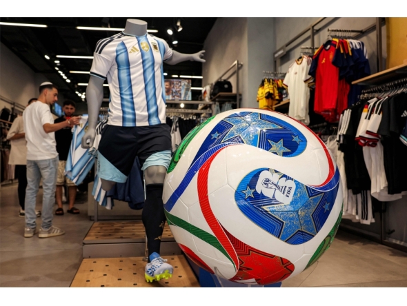(Files) A replica of the Adidas Trionda, the 2026 FIFA World Cup official football ball, is displayed at a sports shop on June 14, 2026. (Photo by Hazem Bader / AFP)