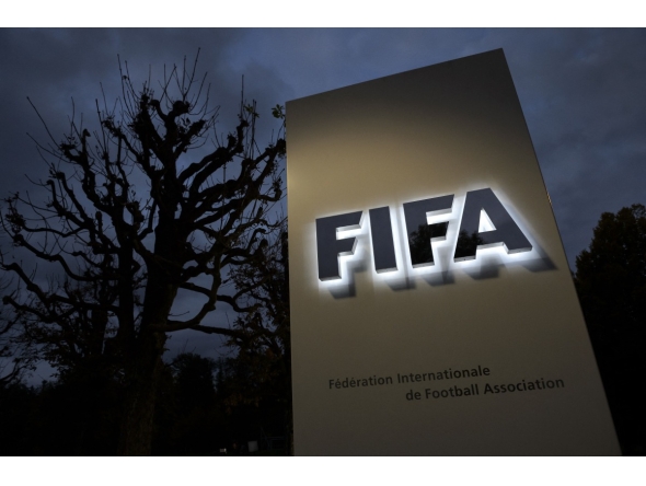 This photo taken on October 8, 2015 in Zurich shows the entrance sign with the logo at the FIFA world headquarters. Photo by Fabrice COFFRINI / AFP