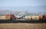 Fire crews spray down the wreckage of a US Marines’ F-35B fighter jet after it crashed into a field near Miramar Air Base in San Diego, California, on July 31, 2026.(Photo by SANDY HUFFAKER / AFP)