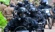 Military personnel wearing anti-riot gear patrol on bikes outside the Mahara Prison complex on the outskirts of Colombo on August 2, 2026. Photo by Ishara S. KODIKARA / AFP