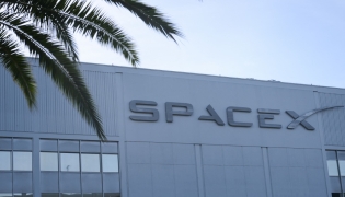 The SpaceX logo is displayed outside a Space Exploration Technologies Corp. facility in Hawthorne, California, on June 8, 2026. Photo by Patrick T. Fallon / AFP