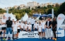 The participating high jumpers pose for a photo with junior athletes ahead of the event.