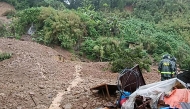 Rescuers work at a landslide site which hit a small restaurant burying three employees who had been in the kitchen, at a village in La Trinidad, Benguet province on August 6, 2026. Photo by AFP