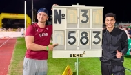 Qatar pole vaulter Saif Mohammed celebrates with his coach after winning the silver medal.