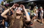 A woman wears eclipse glasses in Almelo, eastern Netherlands on August 11, 2026 on the eve of a partial solar eclipse. Photo by Vincent Jannink / ANP / AFP