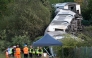 Carriages of a derailed train are pictured on their side, near the town of Lewes, southern England on August 13, 2026. Two people sustained 