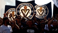 Supporters of French 'Nationale 2' fourth-tier club FC Girondins de Bordeaux wave the club’s flags during a protest ahead of a hearing at the Direction Nationale du Controle de Gestion - DNGG, French football financial watchdog, following the six-time French champions' exclusion from national competitions, in Bordeaux, southwestern France July 19, 2026. Photo by ROMAIN PERROCHEAU / AFP