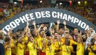 Lens' players celebrate with the championship trophy after winning the French Super Cup (Trophee des Champions) football match between RC Lens and Paris Saint-Germain (PSG) at the Stade Bollaert-Delelis in Lens, northern France on August 16, 2026. (Photo by GEOFFROY VAN DER HASSELT / AFP)