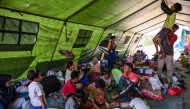 Villagers rest in a tent on an open field in Marapokot, Nagekeo, East Nusa Tenggara, on August 17, 2026, following a 7.7-magnitude earthquake. T (Photo by JUNI KRISWANTO / AFP)