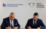 QDE Director, Ghanim Nasser Al-Saadi, and President of the Diamond Exchange of Singapore, Fabio Cascapera, signing the agreement