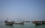 Traditional wooden boats are anchored in front of the Doha skyline on August 19, 2026. (Photo by Mahmud Hams/ AFP)

