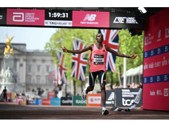 Kenya's Sabastian Sawe crosses the line to win the men's race in a new world record time at the 2026 London Marathon in central London on April 26, 2026. Photo by JUSTIN TALLIS / AFP
