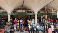 Stranded passengers sit on the pavement as they wait with their luggage by the departure terminal of the Jomo Kenyatta International Airport (JKIA) after staff from the Kenya Airports Authority (KAA) and Kenya Civil Aviation Authority (KCAA) airport workers' go-slow strike action continued into its second day, in Nairobi, on August 31, 2026. Photo by SIMON MAINA / AFP