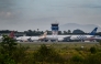 Airplanes sit on the tarmac at Iskandar Muda airport in Blang Bintang on September 6, 2026. Indonesia halted operations at its main international airport outside Jakarta on September 6, after ash spewed from the Anak Krakatoa volcano more than 150 kilometres away, impacting thousands of passengers. (Photo by CHAIDEER MAHYUDDIN / AFP)